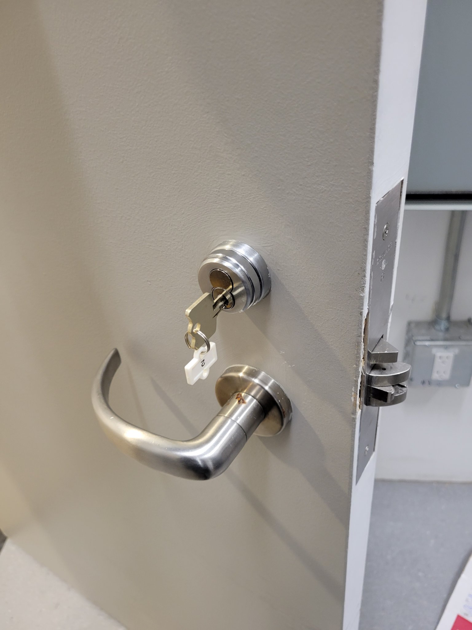 Office door hardware: closer and lock serviced for daily traffic.